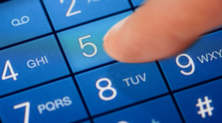 Closeup of person dialling on a phone