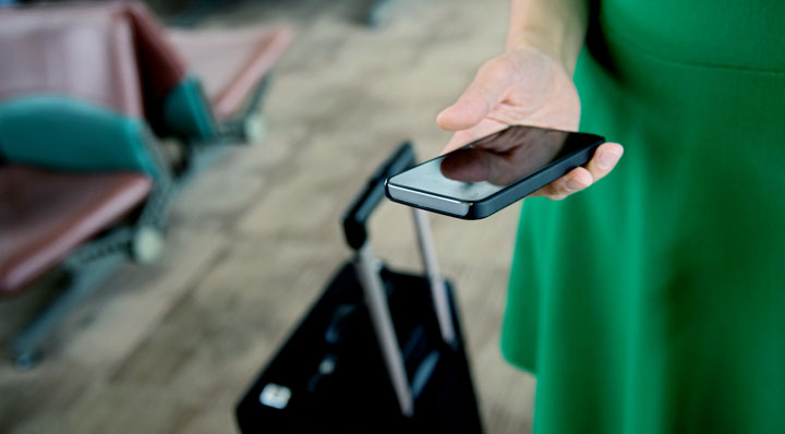 Woman looking at Mobile phone while at travelling